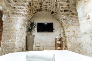 a bedroom with a bed in a stone wall at sermest house in Urfa