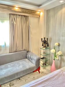 a living room with a couch and a window at 18B Shehb Apartment Hotel in Giza