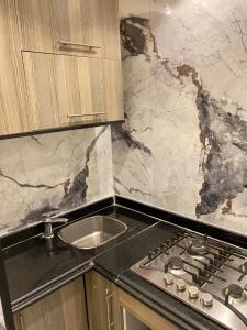 a kitchen with a sink and a counter top at 18B Shehb Apartment Hotel in Giza +76 photos