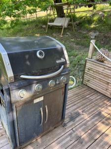 an old stove is sitting on a wooden deck at Chalet studio in Porto Ota