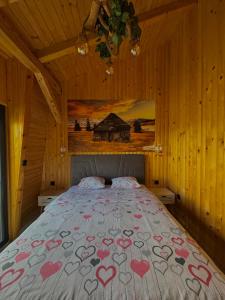 a bedroom with a bed with hearts on it at Vlasic Odmor - Villa Biser & spa in Vlasic