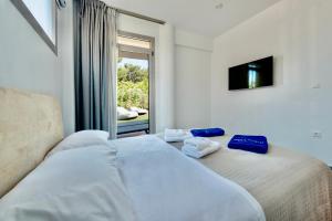 a bedroom with a bed with towels on it at SunBlue Boutique Villas in Skala Rachoniou +55 photos