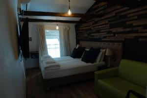 a bedroom with a bed and a window and a couch at Sir Thomas Bed Central in Bolzano