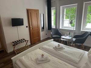 a bedroom with two beds and a table and chairs at Hotel Hohe Reuth in Bocka