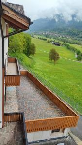 a balcony with a view of a green field at Casa Sartori in Caderzone Terme