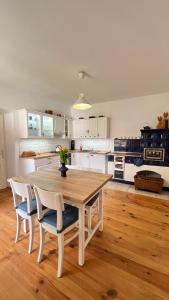 a kitchen with a wooden table and chairs at Statek Bavorov in Bavorov