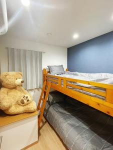 a teddy bear sitting on a shelf in a bedroom at K-House in Tokyo +6 photos