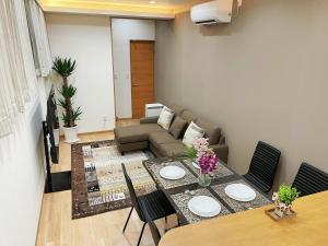 a living room with a table and a couch at K-House in Tokyo