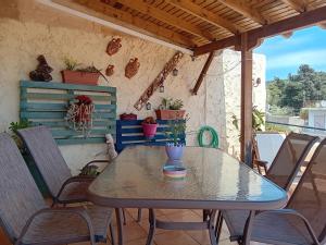 a table and chairs on a patio at Traditional Villa Marina in Chios