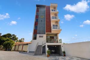 a tall building with a staircase in front of it at AVN Comforts Mysore in Mysore