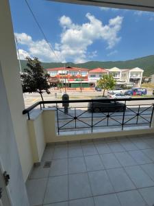 a balcony with a view of a parking lot at Elonia Apartment in Polygryos