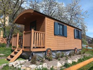 a tiny house sitting on a rock in a yard at La roulotte des foins in Montmaur