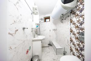 a white bathroom with a toilet and a sink at Вила "Люляк" in Lakarevo +15 photos