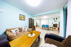 a living room with a couch and a table at Вила "Люляк" in Lakarevo