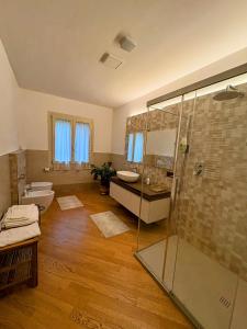 a bathroom with a glass shower and a toilet at Alla Stella B&B in Vo Euganeo +16 photos