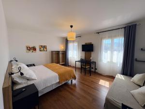 a bedroom with a bed and a desk and a television at Alla Stella B&B in Vo Euganeo