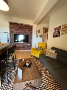 a living room with a couch and a tv at Iria Apartment in Polygryos