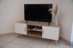 a flat screen tv on a white entertainment center at Casa trani in Ischia