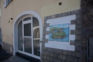 a building with a painting on the side of it at Casa trani in Ischia