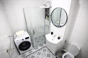 a bathroom with a toilet sink and a mirror at FLH - Sunset Horizon near Shopping City with parking in Şelimbăr +31 photos