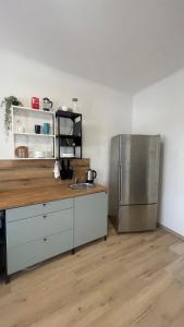 a kitchen with a sink and a refrigerator at Großes Monteurhaus Großharras in Großharras