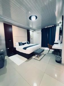 a bedroom with a bed and a sink and a piano at Dikukama Executive Hotel in Tshabong