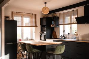 a kitchen with a table and some chairs in it at La bohème Langogne in Langogne +35 photos