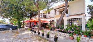 a street with potted plants in front of a building at Studio Rose in Gajac