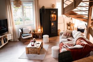 a living room with a couch and a coffee table at La bohème Langogne in Langogne