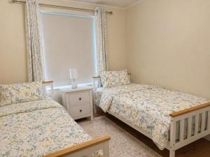 a bedroom with two beds and a window at 2 Bedroom Flat in Manchester