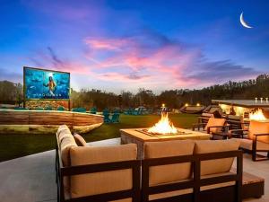a patio with a fire pit and a tv at Smith Creek Resort - Exclusive Waterpark Included in Sevierville