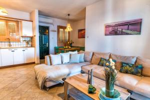 a living room with a couch and a table at Aegean Verde Retreat in Sounio