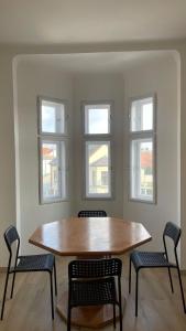 a table and chairs in a room with windows at Großes Monteurhaus Großharras in Großharras +2 photos