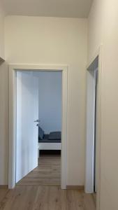 an open door in a room with a bed in the background at Großes Monteurhaus Großharras in Großharras