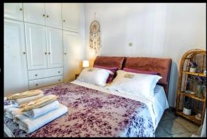 a bedroom with a bed with towels on it at Aegean Verde Retreat in Sounio +25 photos