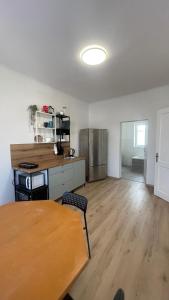 a room with a table and a kitchen with a refrigerator at Großes Monteurhaus Großharras in Großharras