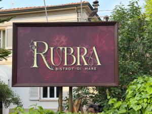 a sign for a rbbu storefront in front of a building at Rubra in Santerno