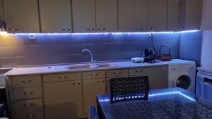 a kitchen with a sink and a washing machine at Galini Cosy Home in Asprovalta +31 photos