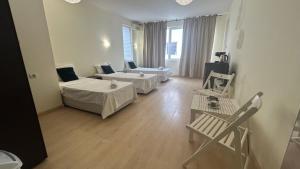 a living room with two beds and a couch at Корал in Obzor