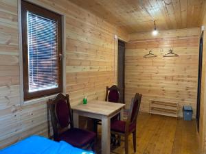 a room with a table and chairs and a window at Nika's house in Mtskheta
