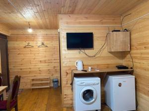 a room with a washing machine and a tv at Nika's house in Mtskheta