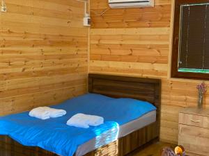 a room with a bed with two towels on it at Nika's house in Mtskheta