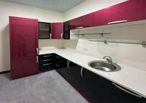 a kitchen with a sink and purple cabinets at Hayot Hotel Skazka in Qarshi