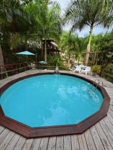 a large swimming pool on a wooden deck at Hacienda Tres Casitas in Cabo Rojo