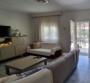 a living room with a couch and a table at Galini Cosy Home in Asprovalta