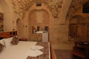 a bedroom with a bed with a hat on it at Helen Olimpos Konağı in Mardin +248 photos