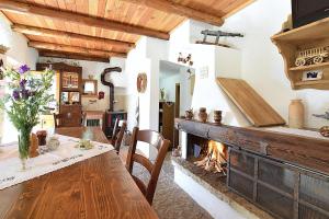 a dining room with a table and a fireplace at Baita Costa Di Gial in Lamon