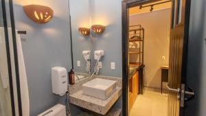 a bathroom with a sink and a mirror at Ap Passarela in Porto Seguro