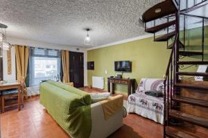 a living room with a couch and a ladder at Banyan Tree in Óbidos