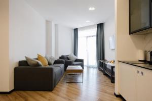 a living room with a couch and a table at Mountain Residence Apartments & Chalet in Bukovel
